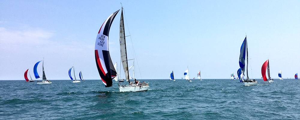 sailboats finishing race with spinnakers